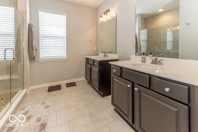 bathroom with tile patterned flooring, vanity, and a shower with shower door