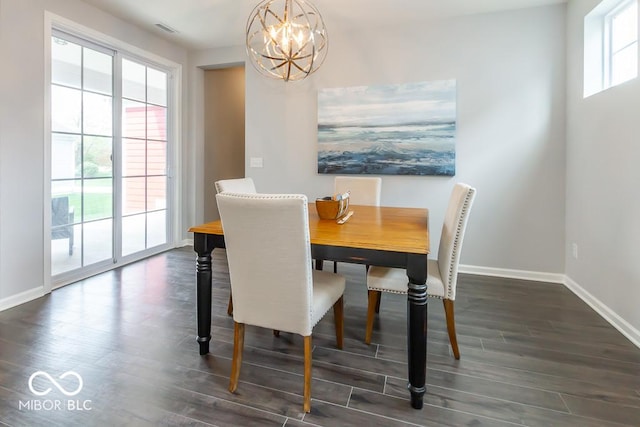 dining room featuring dark wood-type flooring and a chandelier