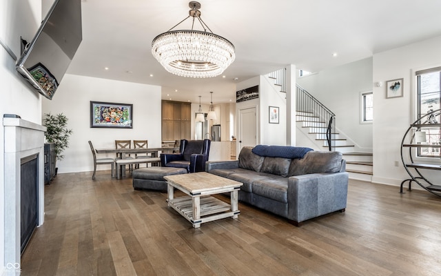 living room featuring dark hardwood / wood-style floors and a notable chandelier