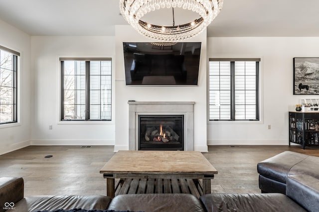 living room with wood-type flooring and a chandelier