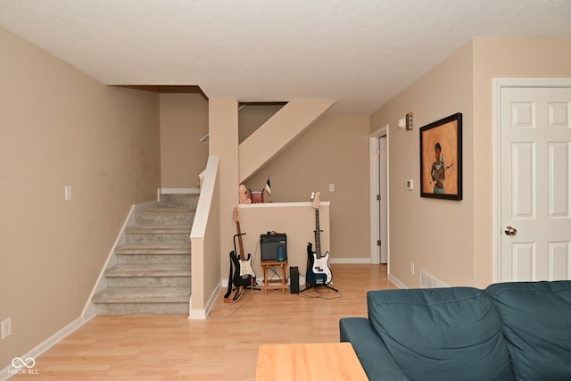 interior space with wood-type flooring and a textured ceiling