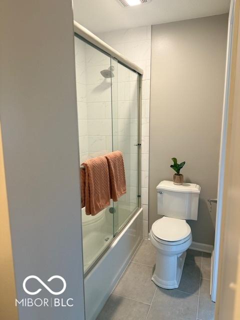 6639 N College Ave, Indianapolis, IN 46220 - full bathroom with toilet, enclosed tub / shower combo, and tile patterned flooring