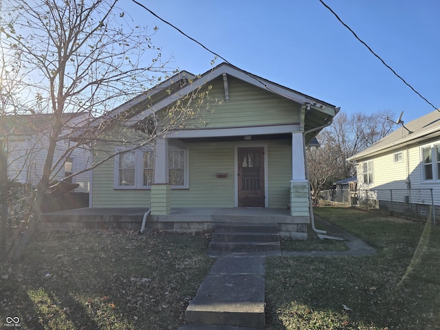 bungalow-style home with a front lawn