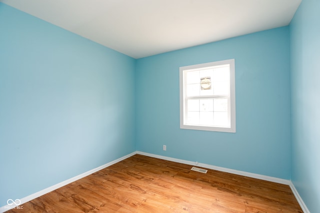 spare room with hardwood / wood-style floors