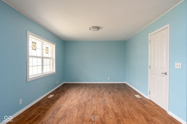 empty room with light hardwood / wood-style flooring