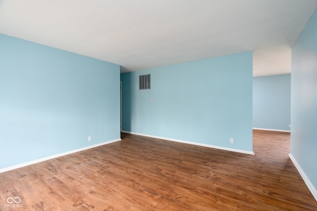 unfurnished room with hardwood / wood-style flooring