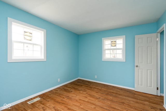 spare room featuring hardwood / wood-style floors