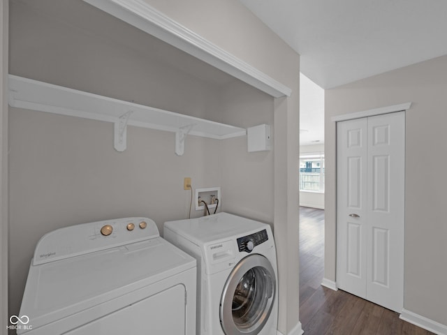 laundry area featuring dark hardwood / wood-style flooring and washing machine and dryer