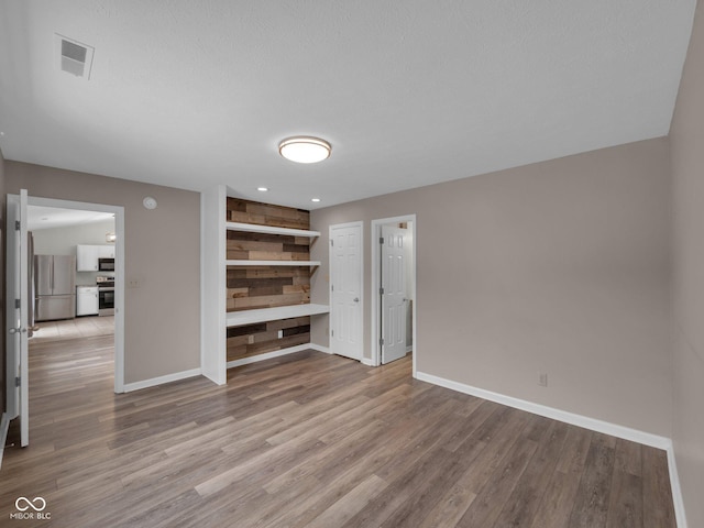 unfurnished living room featuring light hardwood / wood-style flooring