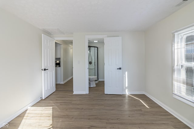 unfurnished bedroom with dark wood-type flooring