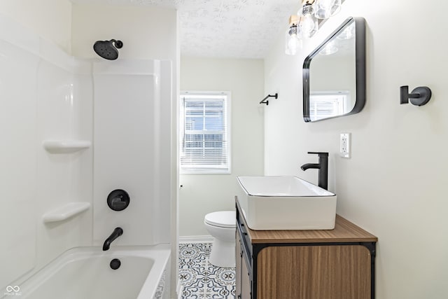 full bathroom featuring vanity,  shower combination, toilet, tile patterned floors, and a textured ceiling