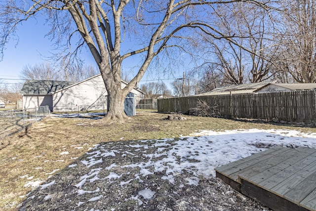 yard layered in snow featuring a fenced backyard