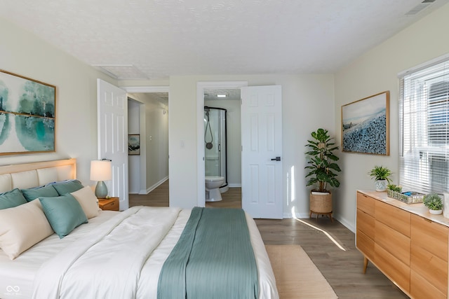 bedroom featuring dark wood finished floors, visible vents, and baseboards