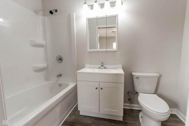 full bathroom with vanity, hardwood / wood-style floors, washtub / shower combination, and toilet