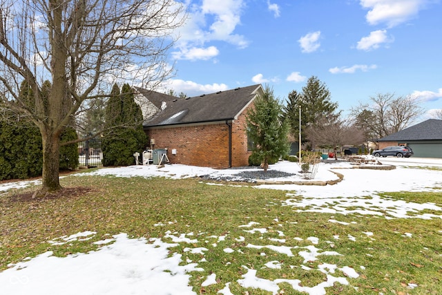 snow covered property featuring a yard