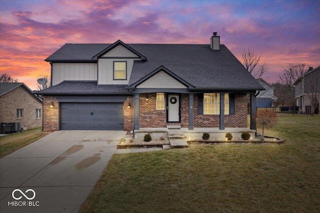 view of front of property with cooling unit, a yard, a garage, and covered porch