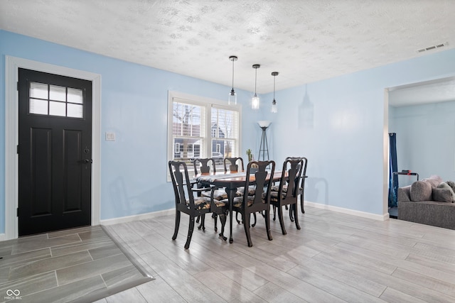 dining room featuring a textured ceiling