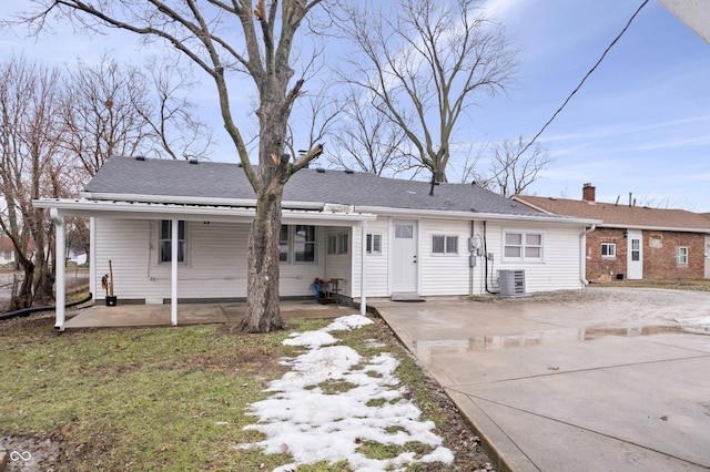 rear view of house featuring a carport and cooling unit