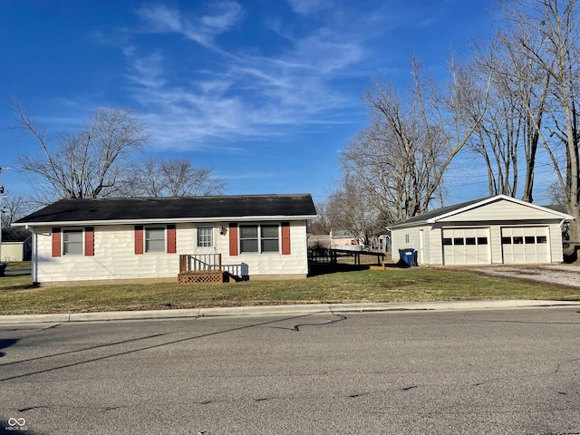 ranch-style home with an outbuilding, a garage, and a front yard