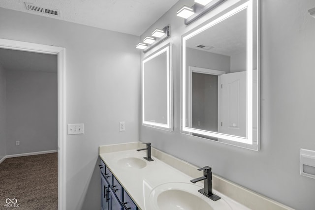 bathroom featuring vanity and a textured ceiling