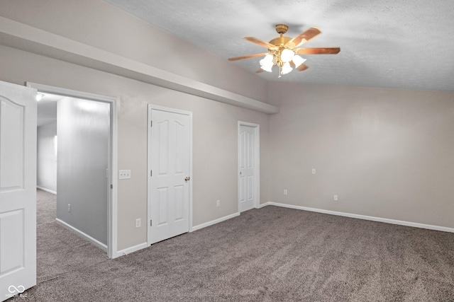 unfurnished bedroom with ceiling fan, lofted ceiling, carpet flooring, and a textured ceiling