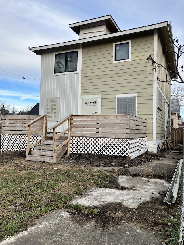 back of house featuring a deck