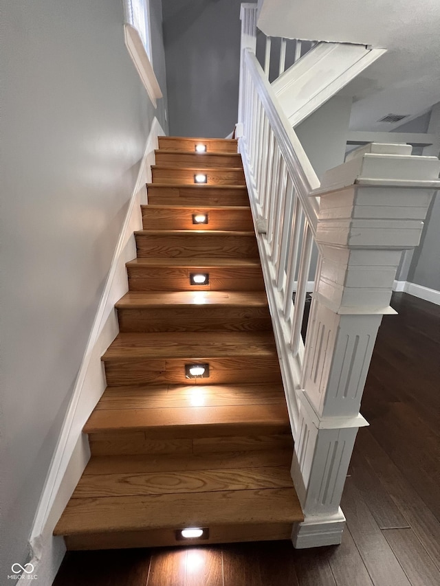 stairway with hardwood / wood-style flooring