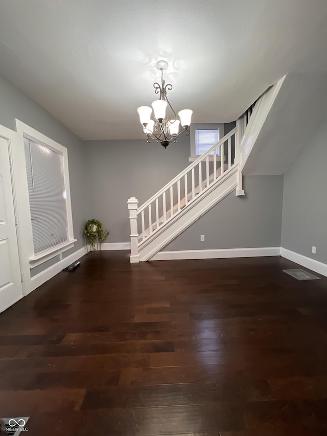 interior space featuring dark hardwood / wood-style floors and a chandelier