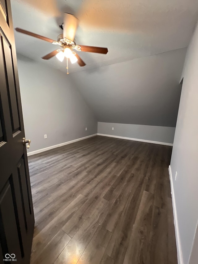 additional living space featuring vaulted ceiling, ceiling fan, and dark hardwood / wood-style flooring