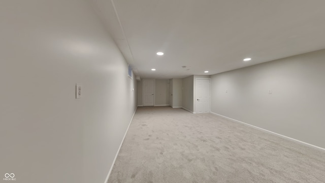 basement featuring light colored carpet