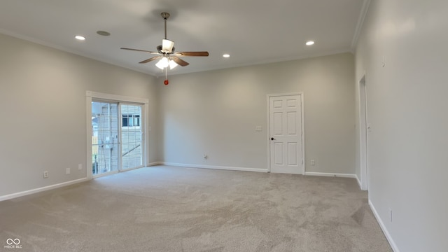 carpeted empty room featuring crown molding and ceiling fan