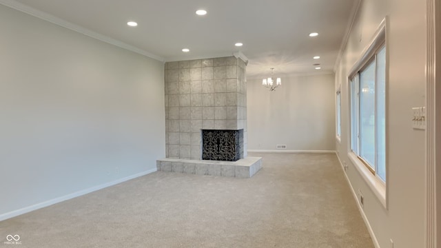 unfurnished living room featuring ornamental molding, a large fireplace, light colored carpet, and an inviting chandelier