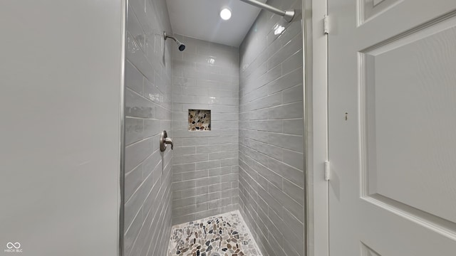 bathroom with a tile shower