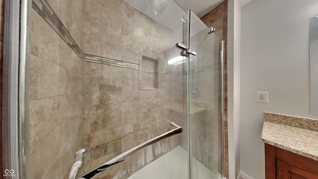 bathroom with vanity and a shower with shower door