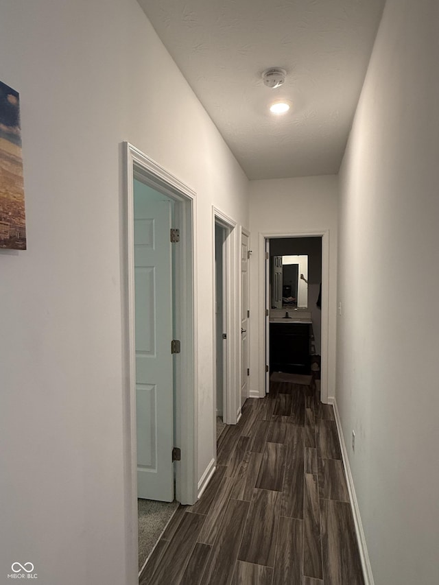 corridor featuring dark hardwood / wood-style floors