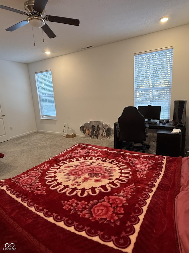 bedroom featuring ceiling fan and carpet