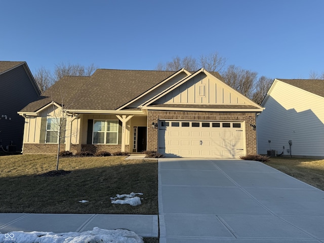 view of front of property with a garage, cooling unit, and a front yard