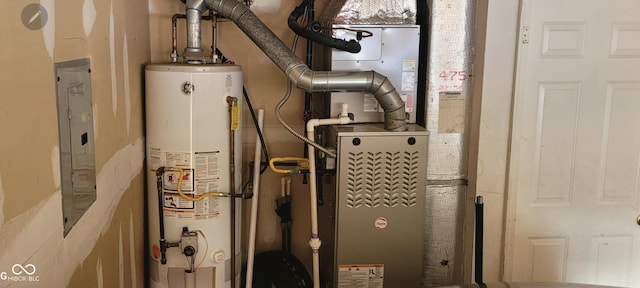 utility room featuring heating unit, gas water heater, and electric panel