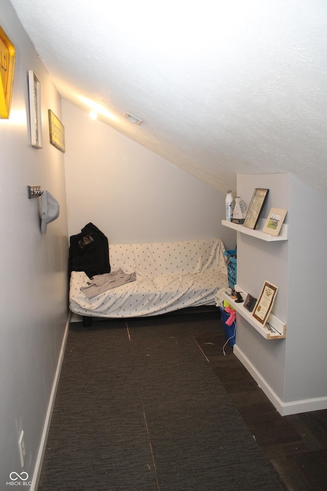 unfurnished bedroom with dark carpet