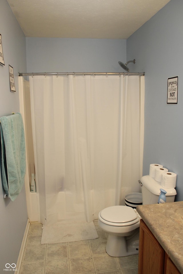 bathroom featuring vanity, tile patterned flooring, curtained shower, and toilet