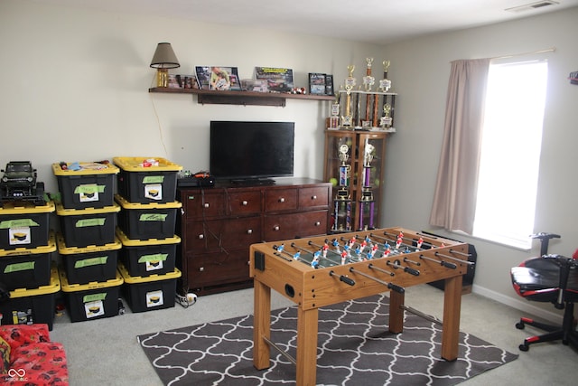 recreation room with light carpet