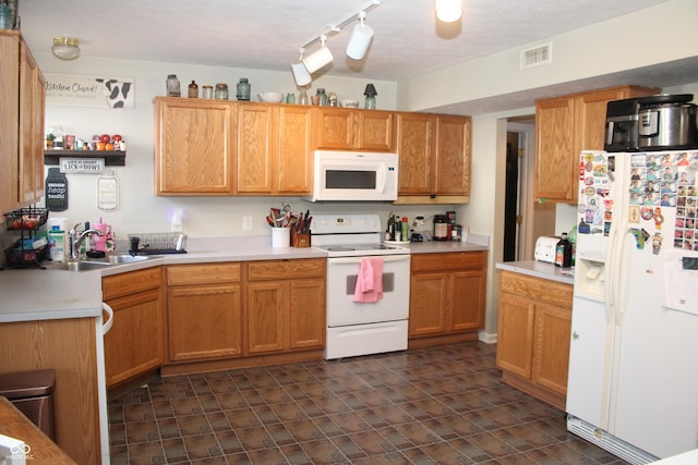 kitchen featuring sink and white appliances