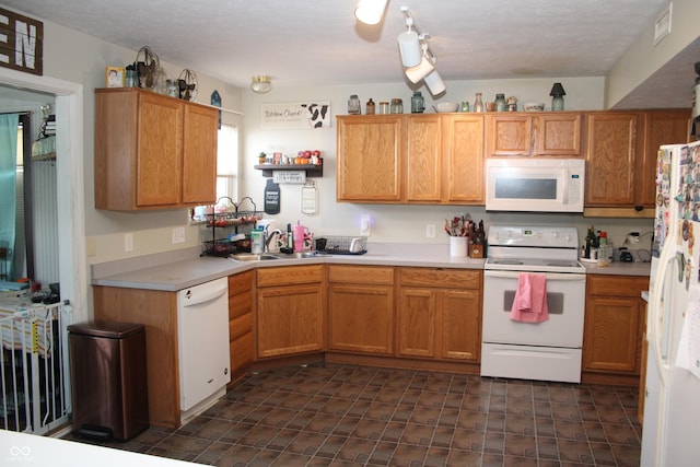 kitchen with white appliances and sink