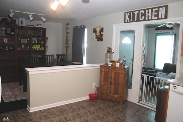 kitchen featuring a textured ceiling and ceiling fan