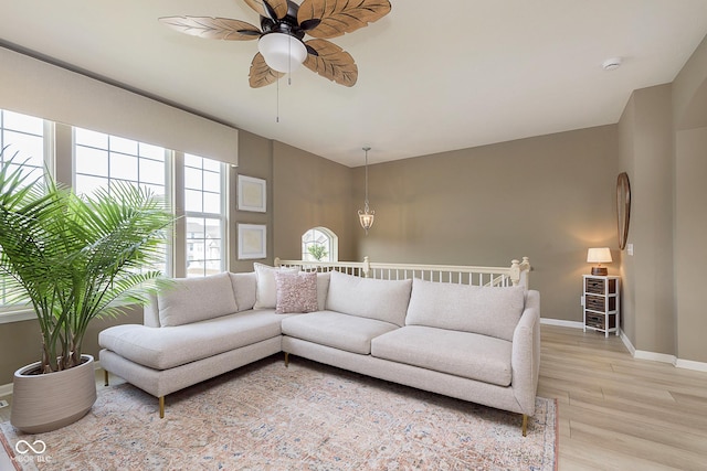 living room with light hardwood / wood-style flooring and ceiling fan