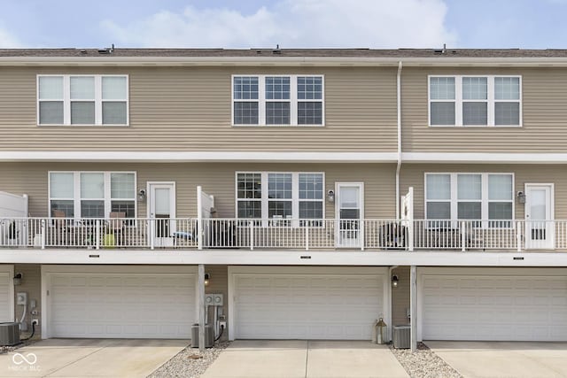 view of front of home featuring a garage and central AC unit