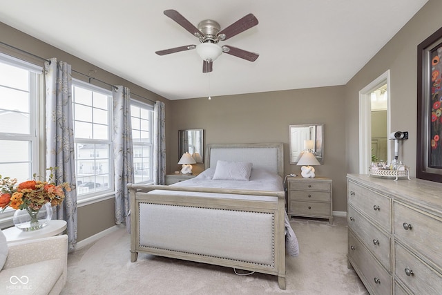 bedroom featuring light carpet and ceiling fan