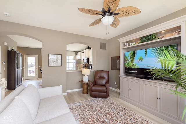 living room featuring ceiling fan and light wood-type flooring