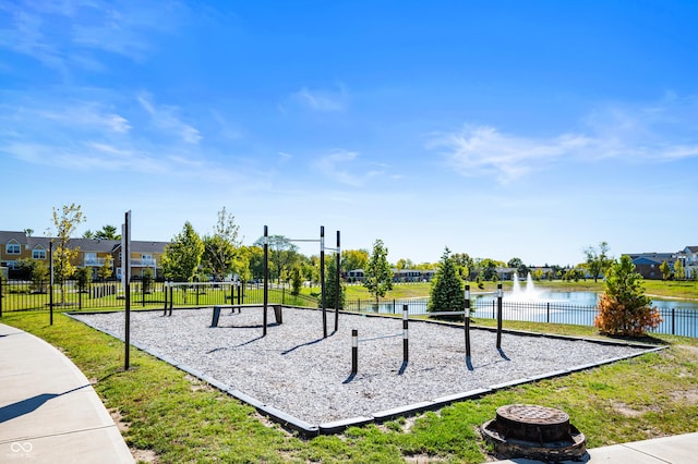 view of property's community with a water view and a yard