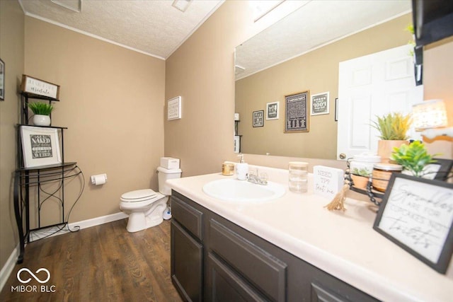 bathroom with vanity, a textured ceiling, wood-type flooring, and toilet